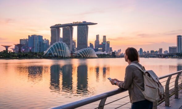 Traveler admiring Singapore's Marina Bay Sands and skyline at sunset during a few days in Singapore